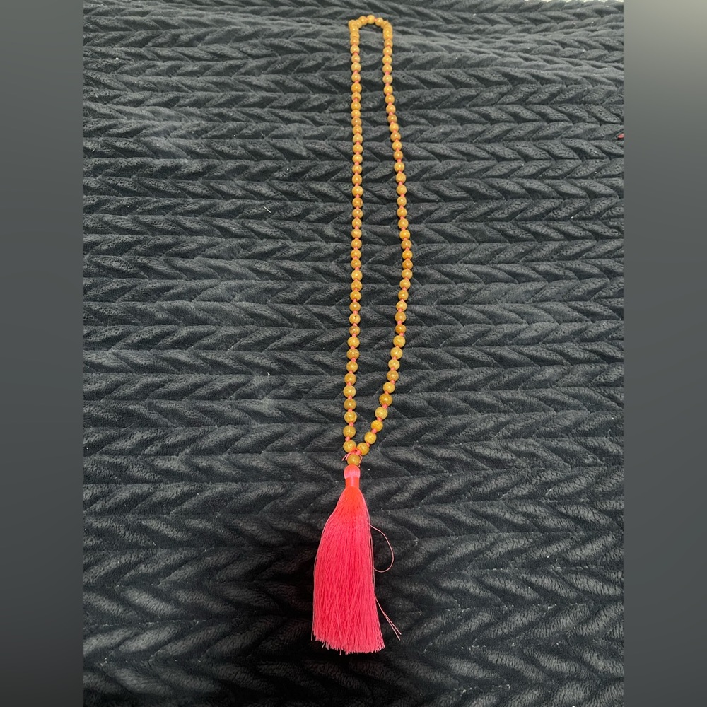 Long pink necklace.